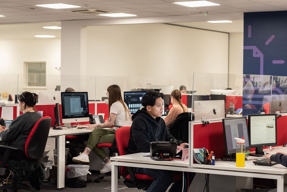 room of designers
          working at their desks