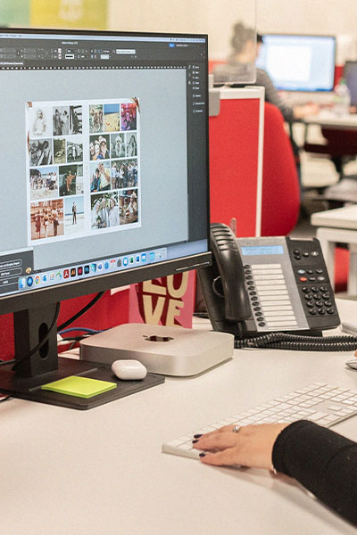 Graphic Designer working on a Mac computer